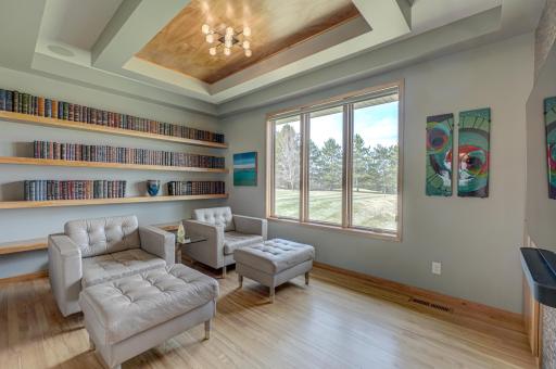 A beautifully finished library with custom shelving provides a quiet retreat.