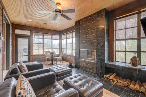 Four-season room with a wood-burning fireplace opens to a maintenance-free deck with a direct gas line for grilling.