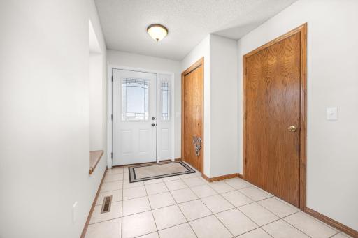 Spacious foyer with closet and mudroom access.