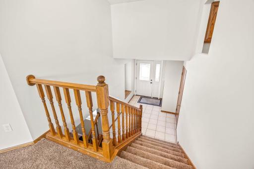 Moving on downstairs, you see the open light filled foyer with built-in storage bench to the left and a newer front door (2021).