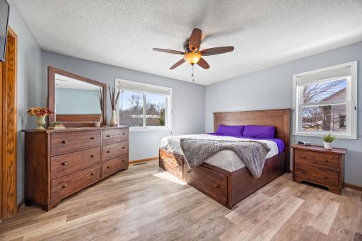 Large primary bedroom on the upper level offers ample room for a king size bed, night stands and dresser in addition to the walk-in closet.