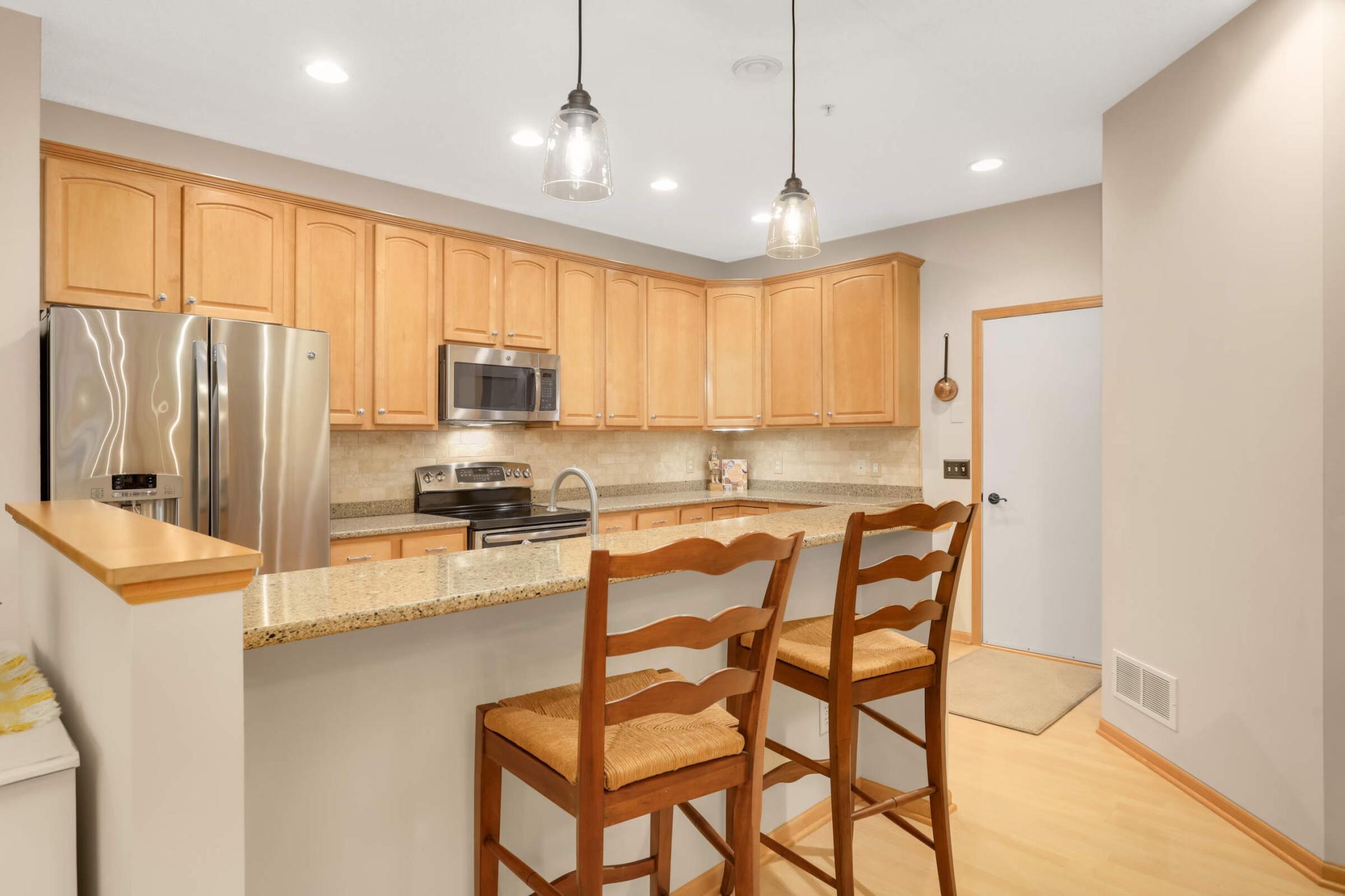 This home offers 42" maple cabinetry, granite countertops, tile backsplash, stainless steel appliances, upgraded hardware and under-cabinet lighting. You'll love this breakfast bar for additional seating.