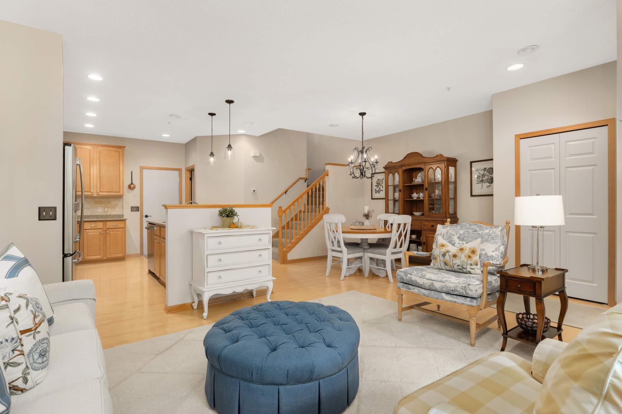 Open living room seamlessly flows into the kitchen and dining area, highlighted by recessed lighting and elegant fixtures.