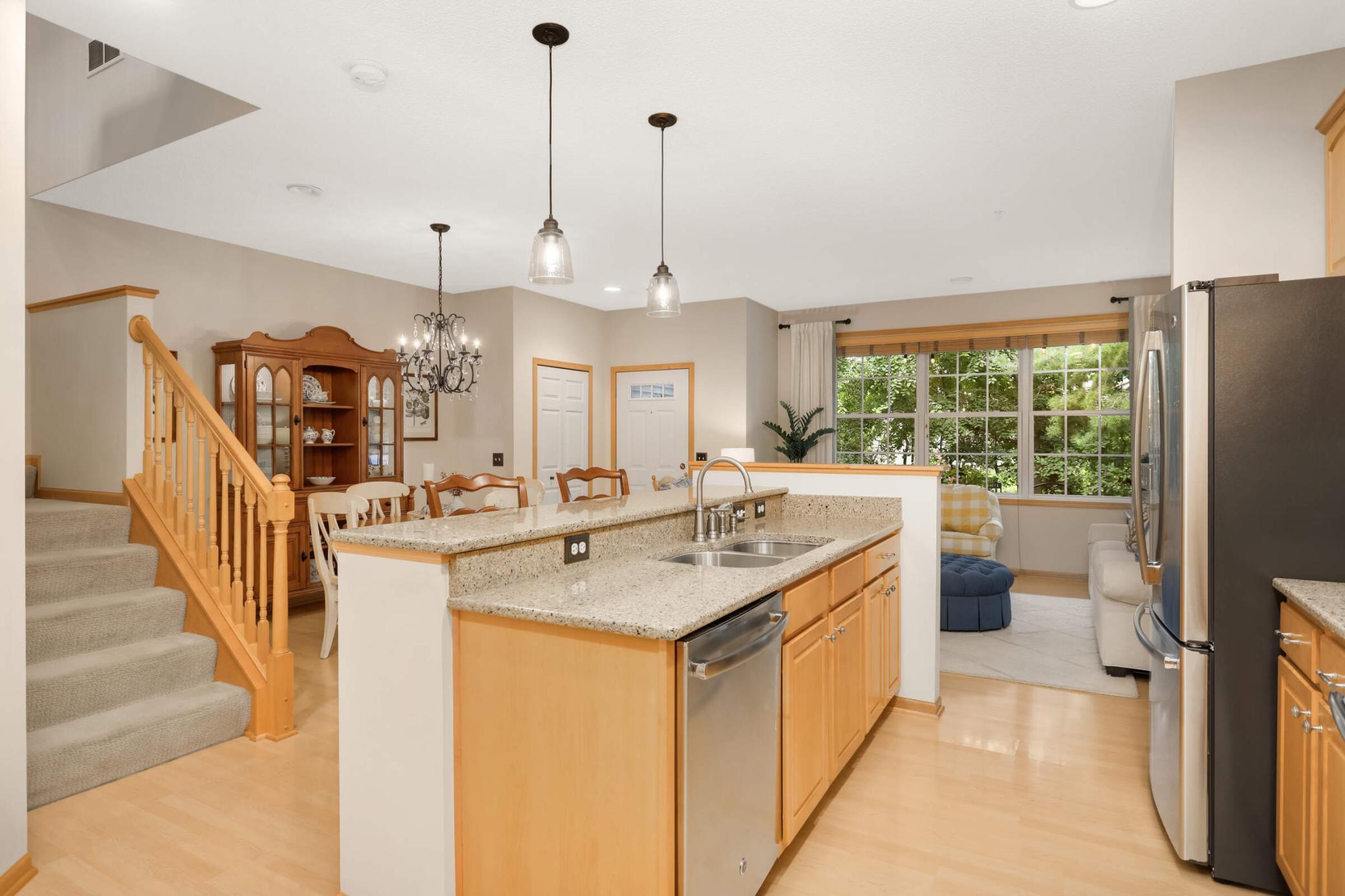 Upgraded kitchen featuring maple cabinetry, Cambria quartz countertops, an undermounted stainless dual sink, and high-end fixtures for a polished, modern look.