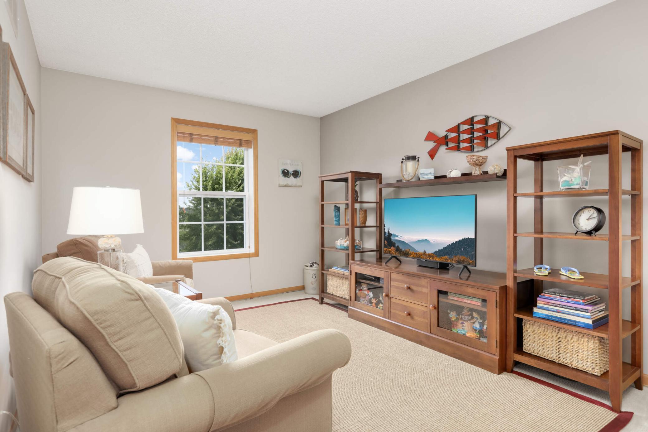 The upper level loft provides a flexible space for a second living area or home office, with views of the Gleason Farms pond and fountain.