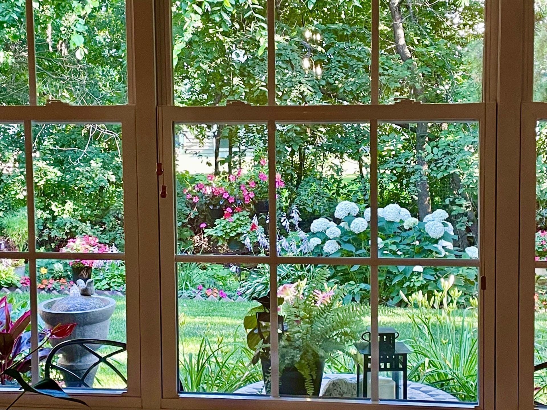 Gorgeous view out the living room window in the summer when the flowers are in full bloom!