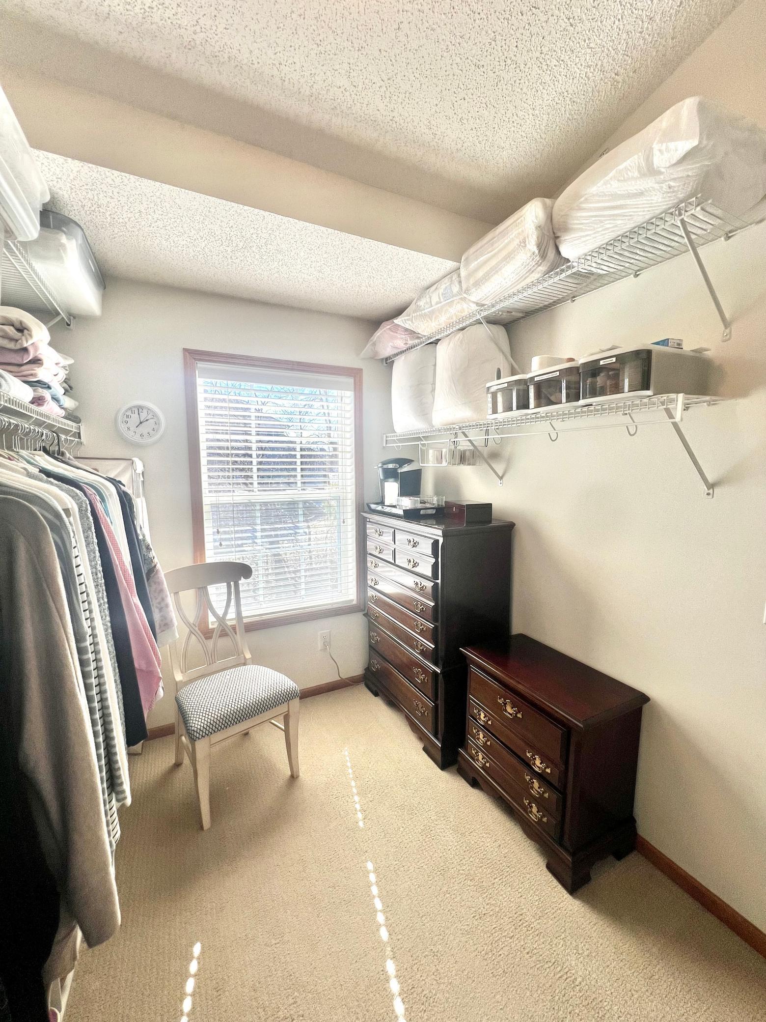 Primary bedroom closet with plenty of natural light.