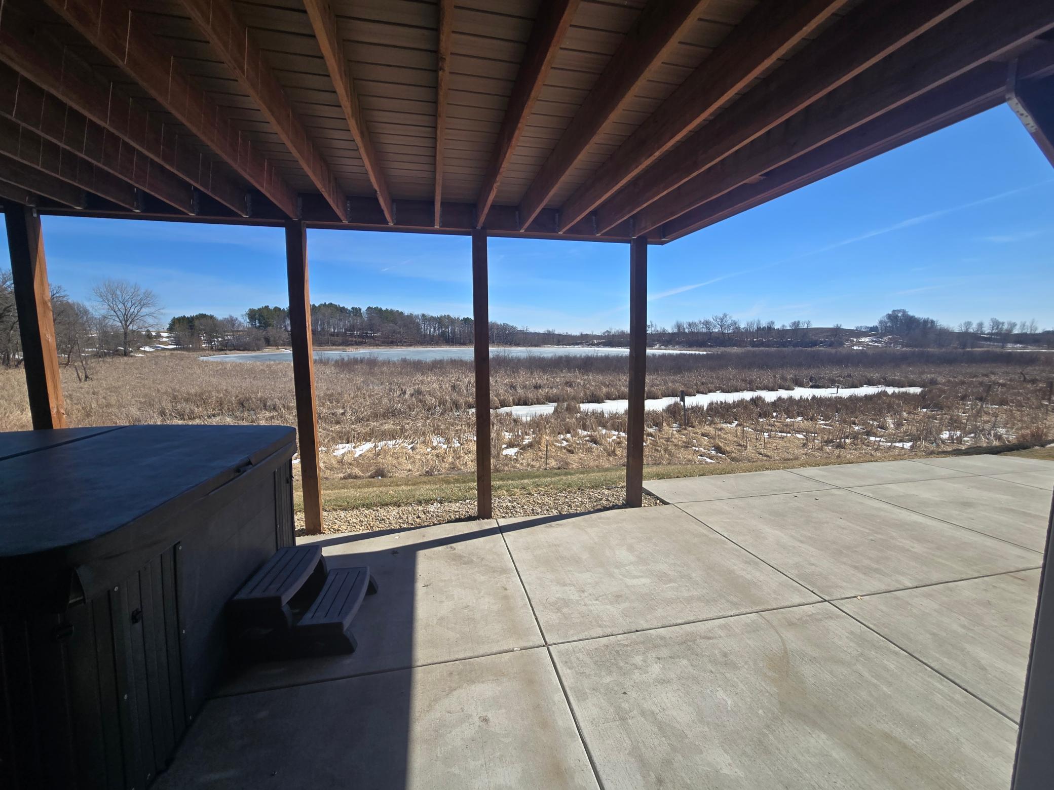 Here we have the view of the back patio from the brand new Lower level Family room, Check out the peaceful pond views, the oversized back patio that measures @ 44' x 16', And the 8 person Jacuzzi /Hot tub. Just imagine the fun evenings you can have!