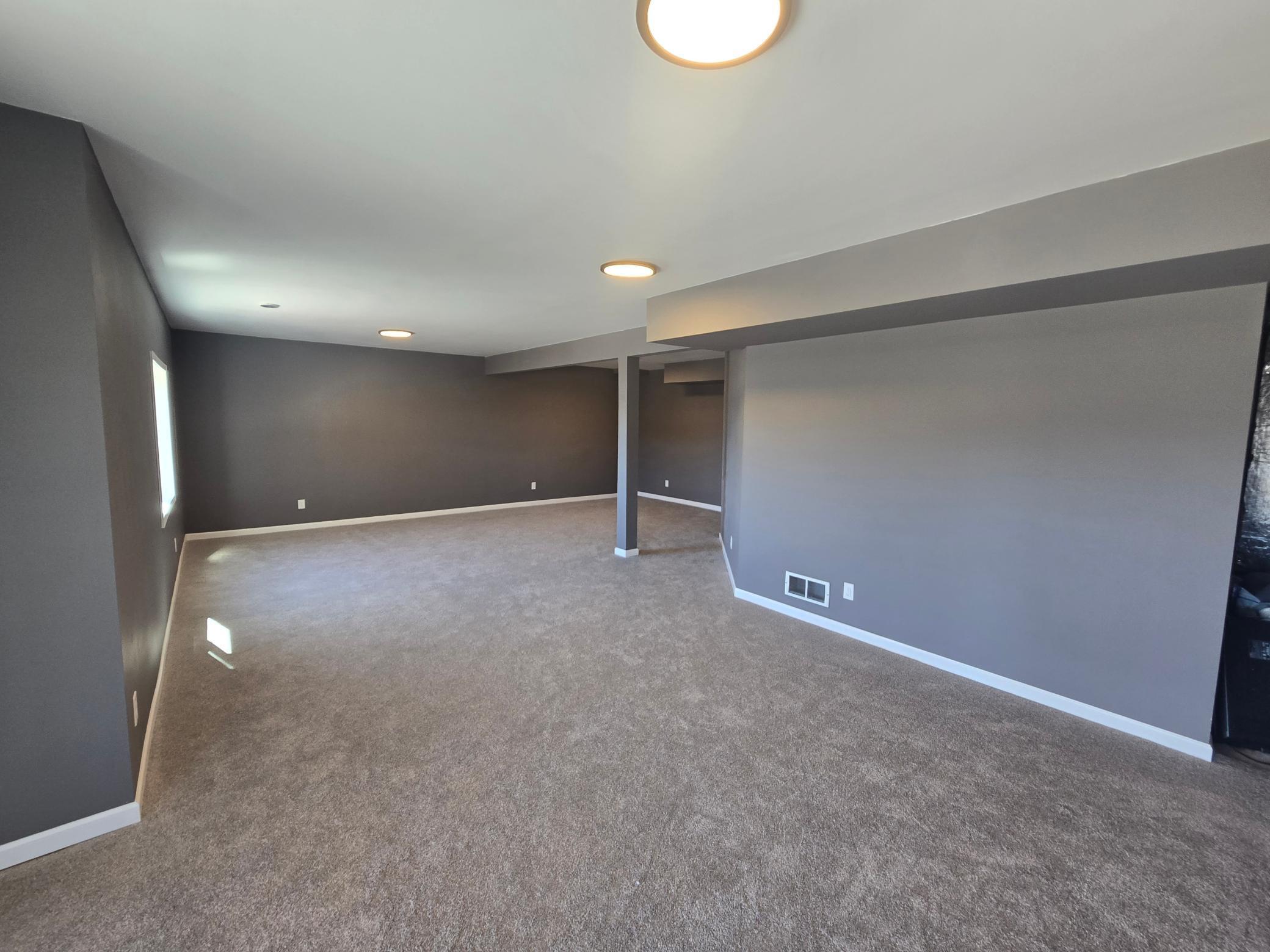 Another view of the newly finished Family Room from the opposite side, Take A look at the recessed lighting and Brand New Carpeting!