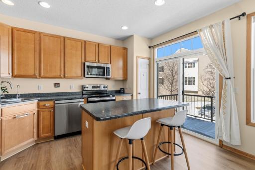 The sliding door opens onto a secure balcony that sits above the home's garage. This is a perfect spot for kiddos or pets to play in the sunshine. It's also a great spot for your herbs and veggies!