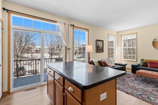 A convenient kitchen island serves as both a breakfast bar and additional meal prep space.