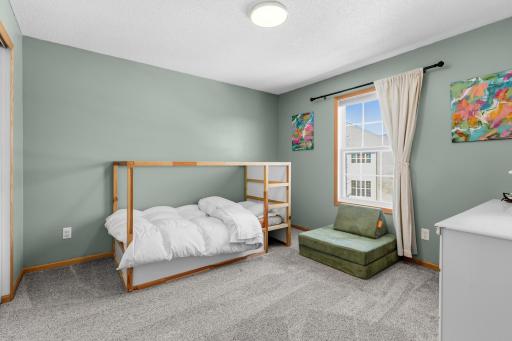 The first of two secondary bedrooms on the upper level.
