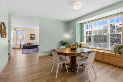 A custom-built window seat, complete with storage, fills the bay window. It could easily be used for seating at a larger farm-house style table.