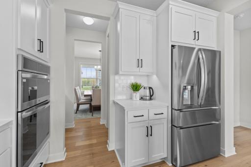 Transitioning from the kitchen to dining, you will find a generous walk in pantry & additional service or coffee station!