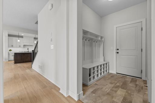 Back entrance with custom storage built ins keeping your family organized. Across from this is a spacious walk in closet.