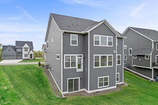 This custom 2024 built Robert Thomas Home St. Croix plan is situated on a desirable walk out home sight.