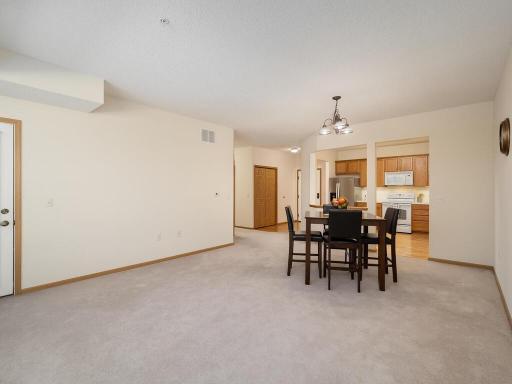 Living room looking toward kitchen. New owner will choose new carpet.