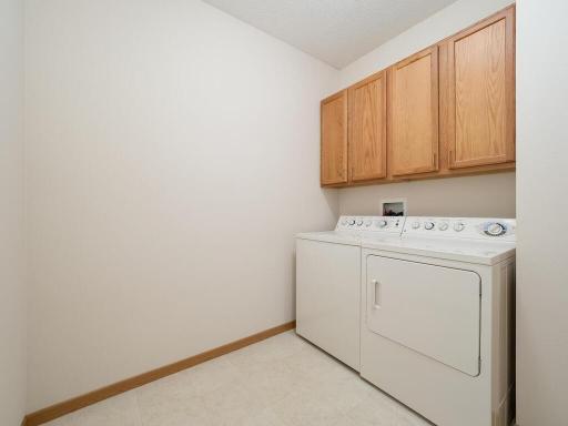 Large laundry room with full-size washer and dryer.