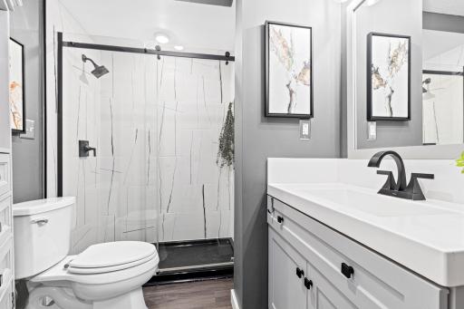 Clean lines, a bold tile pattern, and white cabinetry with black pulls, this updated bathroom strikes the perfect balance between spa-like calm and contemporary edge.