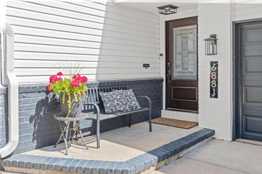 Before you ever step inside, this entry tells you everything you need to know about how this home has been kept. Fresh paint, new lighting, beautiful door, and flowers in bloom. The care here is visible from the curb.