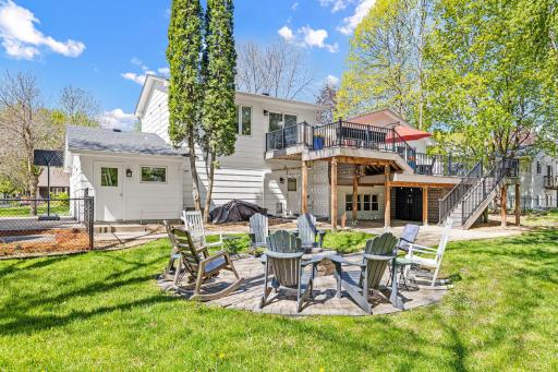 From the elevated deck to the paver fire pit patio below, this backyard was designed for living out loud. Built-in storage under the deck keeps everything tidy. The Adirondack chairs are just waiting for you.