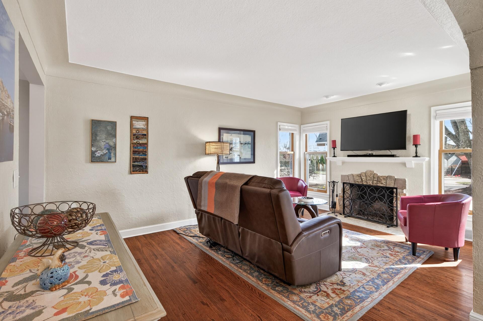 Relax in the cozy living room with hardwood floors and wonderful natural light