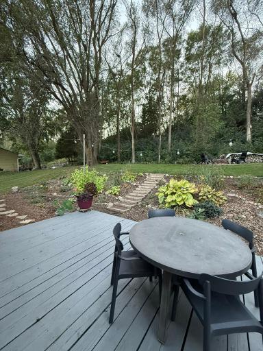 Backyard view with private wooded area deck table.JPEG
