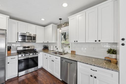 Kitchen has an open concept with granite counter tops and stainless steel appliances.