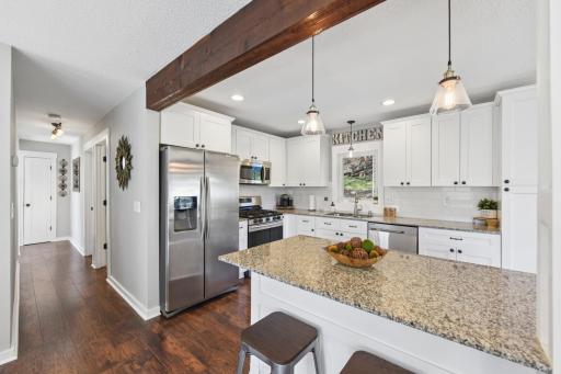 Kitchen and center island with granite counter tops.