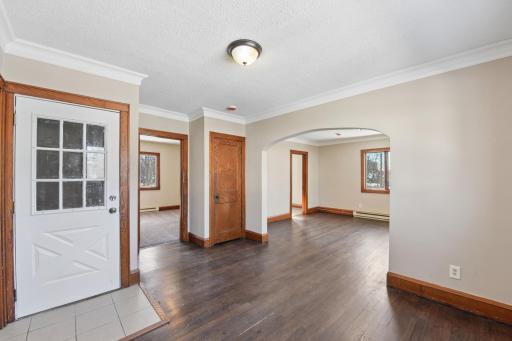 Welcoming entry into the main living area with original wood trim and open-concept feel.