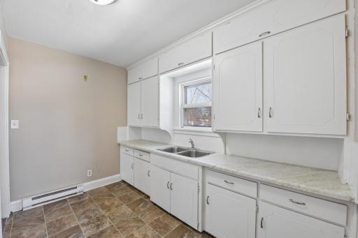 Generous cabinet storage and workspace with natural light enhancing the kitchen area.