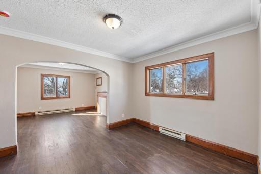 Expansive living area with hardwood floors and open sightlines, perfect for entertaining.