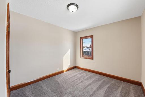 Cozy bedroom with natural light and neutral tones, ideal for guests, office, or flex space.