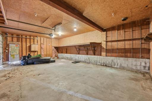 Large garage space with extensive shelving and room for vehicles, storage, or workspace needs.