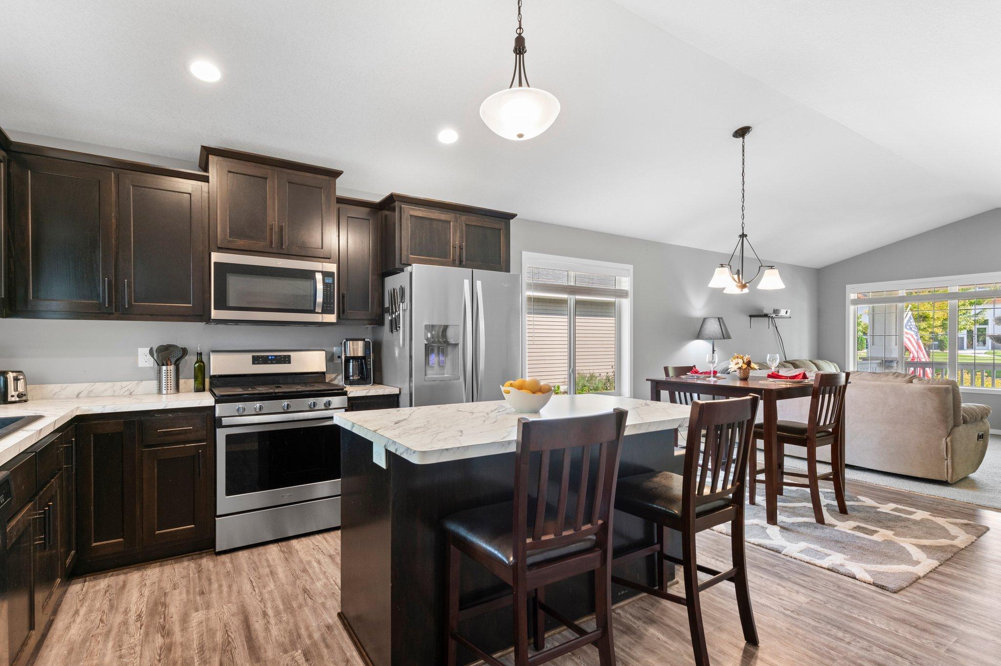 Another view of the kitchen that has ample storage and a pantry.