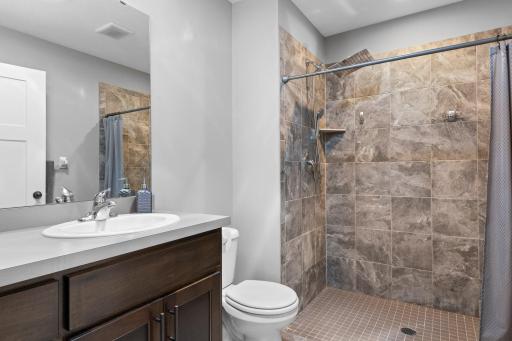 Primary private bath has a great walk-in tiled shower.