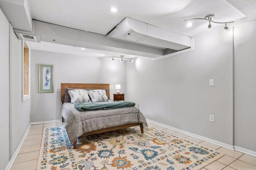 The lower level offers a private suite with its own sitting room and powder room ideal for guests, multi-generational living, or a flexible space for hobbies, movies, or game nights