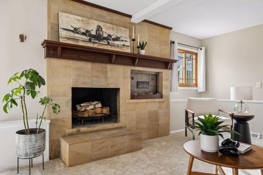 A beautifully renovated fireplace creates a stunning focal point, adding warmth and character to the space
