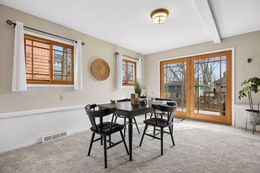 Sunlight pours in through the glass door, which opens directly to the patio and terraced backyard—perfect for easy indoor-outdoor living