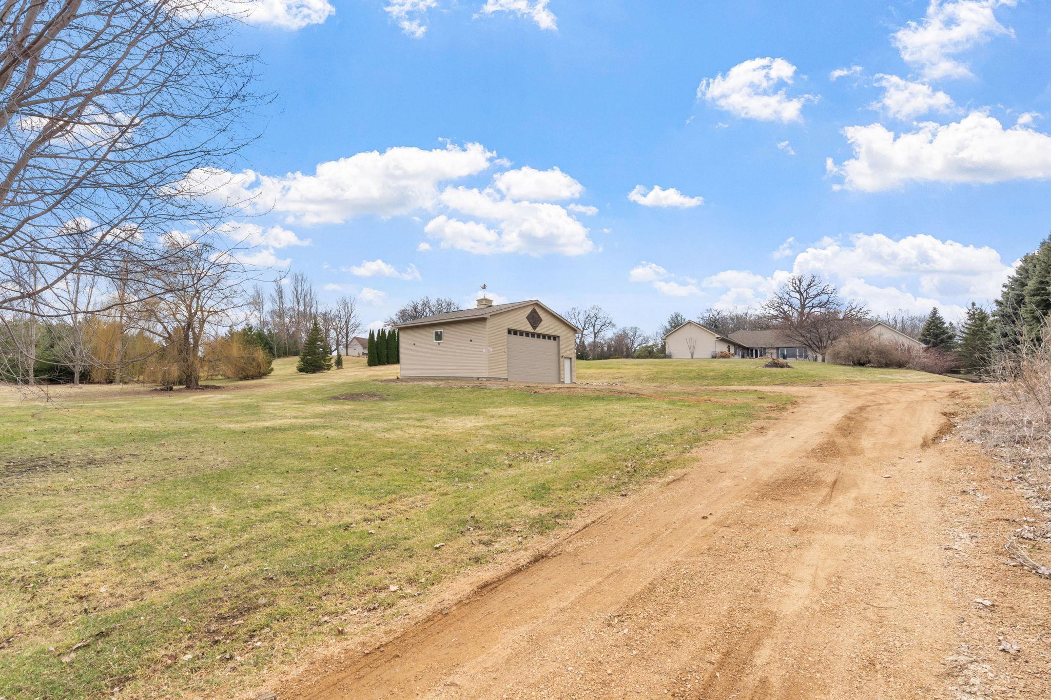 Two entrances to the home, easily access the out building from this dirt road in the back of the house
