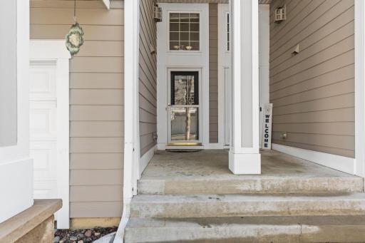 The large window above the door lends to a grand, well-lit entrance.ntr