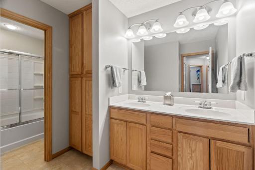 Upstairs bathroom with double vanity and a very generously sized linen closet.