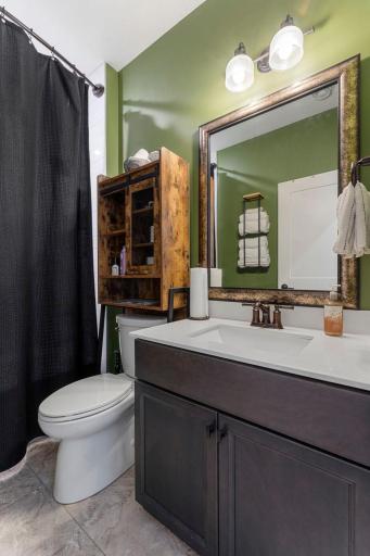 Conveniently located near a full bathroom which includes a tub/shower combination with floor-to-ceiling tile.