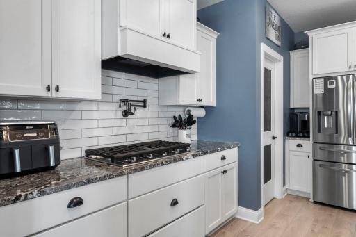 Premium upgrades, including a gas cooktop with pot filler and a wall oven, add both style and functionality.