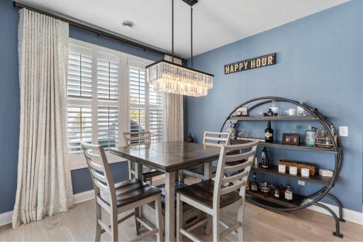 Nearby designated dining space with large windows and statement lighting, perfect for daily use or gatherings.
