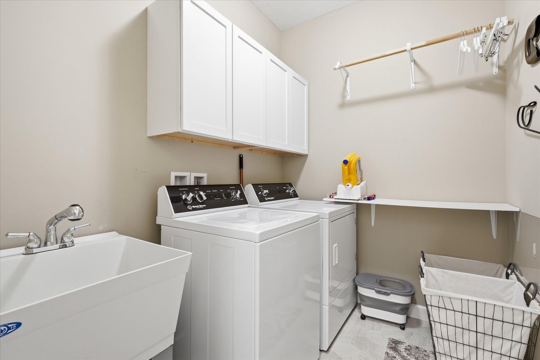 Main level large laundry with sink. Washer and dryer included