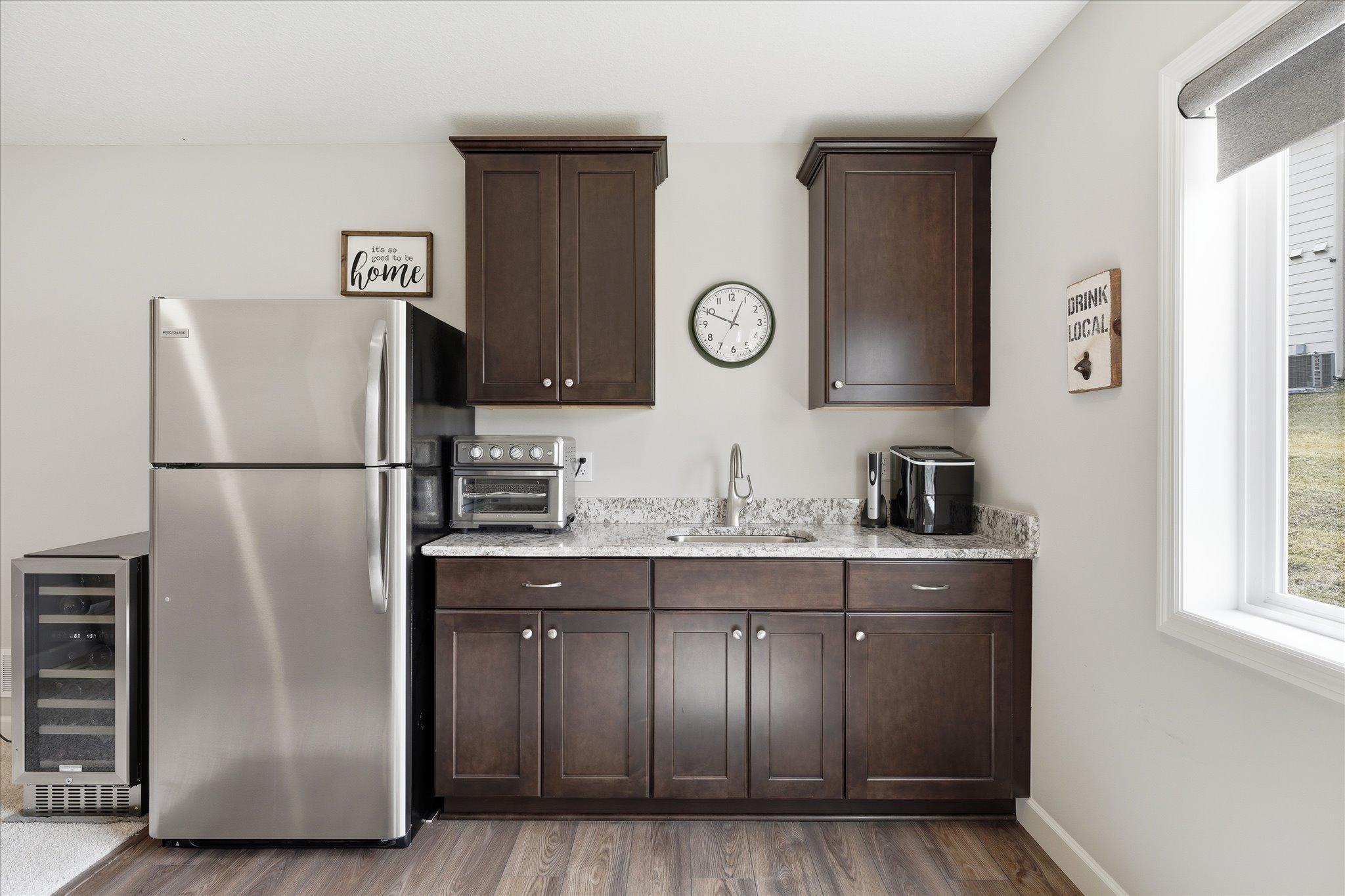 Family room wet bar with full refrigerator and wine frig. Game changer!