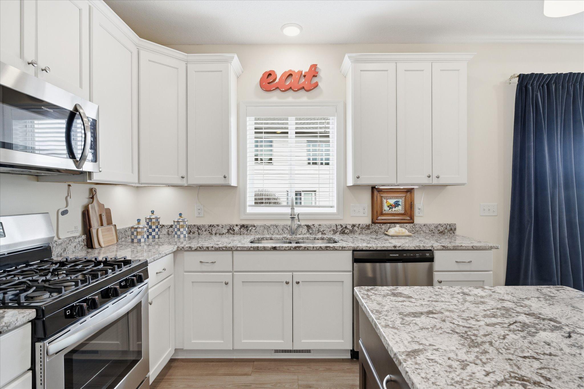 Open kitchen with maintenance free, stone countertops and soft close cabinets. A beautiful bright and open design