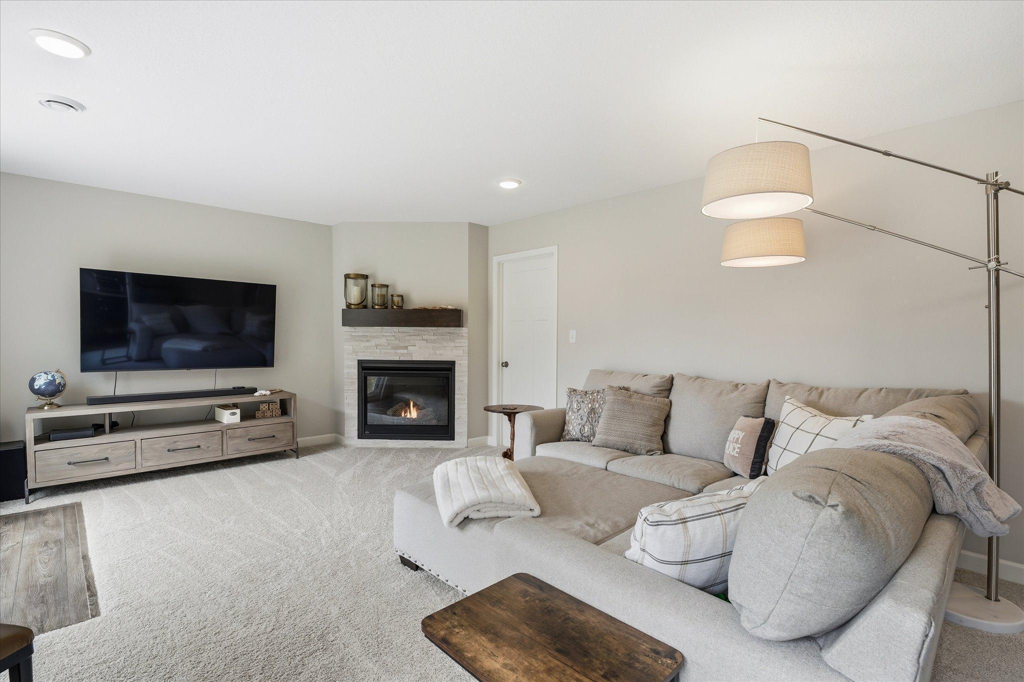 Lower level family room with gas fireplace and walk-out to patio area.