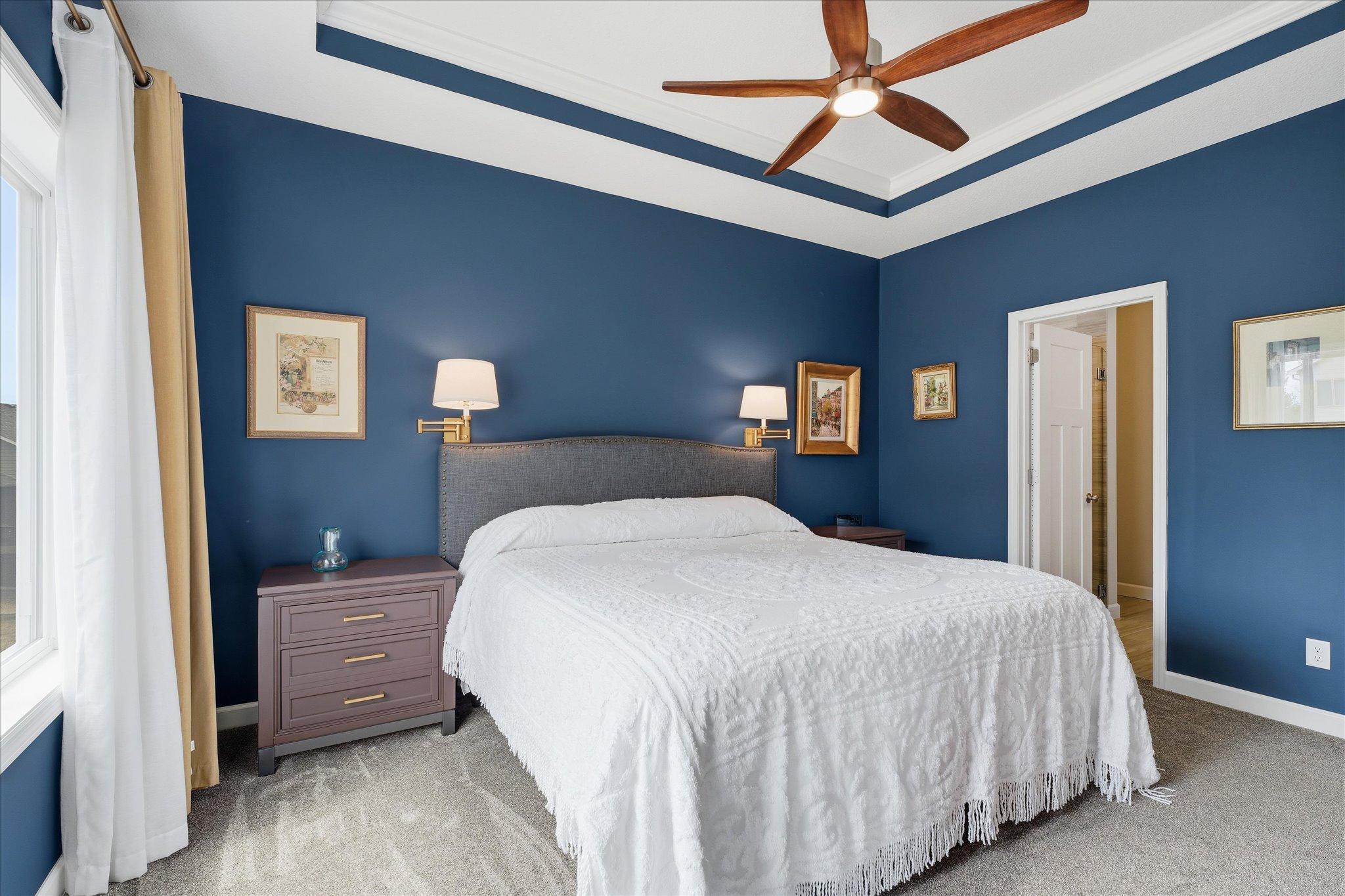 The primary suite has a dramatic and warm feel. Dramatic ceiling feature. A must see to experience the ambiance.